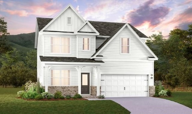 2417 Williams Ridge Dr, Columbia, TN 38401 - view of front of home with a garage, a lawn, concrete driveway, board and batten siding, and brick siding