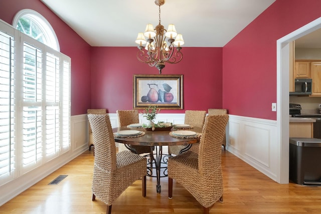 1513 Bunbury Dr, Thompsons Station, TN 37179 - dining area with a chandelier, light wood-type flooring, and wainscoting