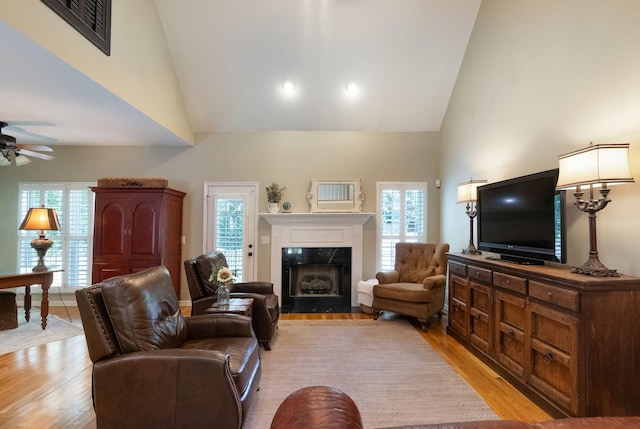 1513 Bunbury Dr, Thompsons Station, TN 37179 - living room with high vaulted ceiling, a ceiling fan, a fireplace, and light wood-type flooring