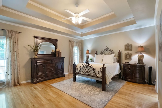 1513 Bunbury Dr, Thompsons Station, TN 37179 - bedroom with a raised ceiling, multiple windows, light wood-style flooring, crown molding, and a ceiling fan