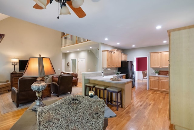 1513 Bunbury Dr, Thompsons Station, TN 37179 - kitchen featuring open floor plan, refrigerator with ice dispenser, light brown cabinets, a breakfast bar, and recessed lighting