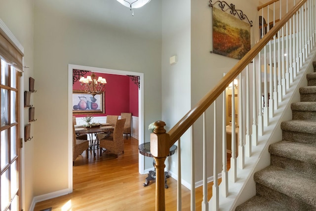 1513 Bunbury Dr, Thompsons Station, TN 37179 - foyer with light wood-type flooring, stairs, a towering ceiling, a chandelier, and baseboards