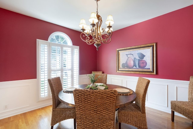 1513 Bunbury Dr, Thompsons Station, TN 37179 - dining room with a chandelier, wainscoting, light wood-style flooring, and a decorative wall