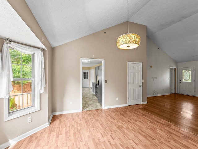 1611 Lincoln St W, Tullahoma, TN 37388 - unfurnished living room featuring high vaulted ceiling and light wood-style flooring