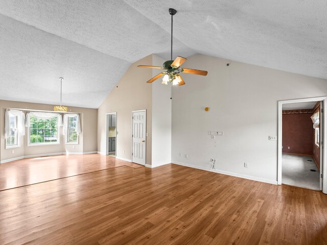1611 Lincoln St W, Tullahoma, TN 37388 - unfurnished living room featuring a textured ceiling, wood finished floors, a ceiling fan, and high vaulted ceiling