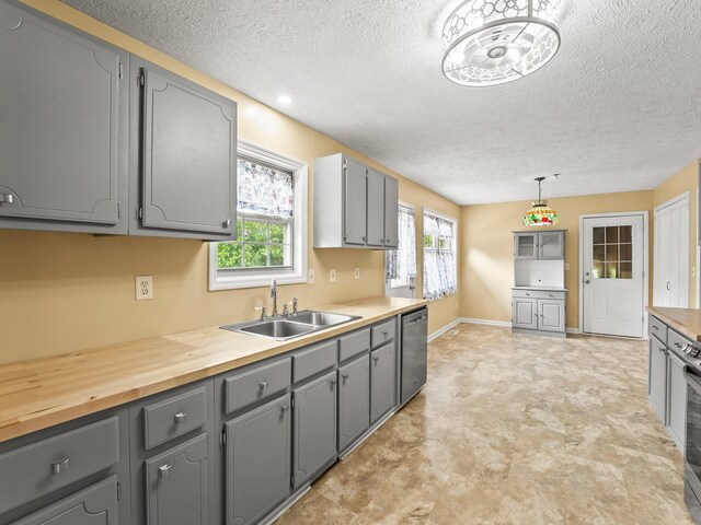 1611 Lincoln St W, Tullahoma, TN 37388 - kitchen featuring gray cabinetry, stainless steel dishwasher, a textured ceiling, and butcher block counters