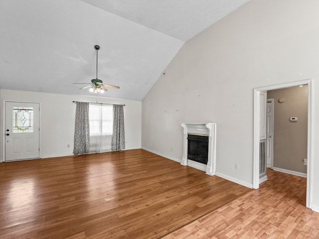 1611 Lincoln St W, Tullahoma, TN 37388 - unfurnished living room featuring a ceiling fan, plenty of natural light, a fireplace, light wood-type flooring, and high vaulted ceiling