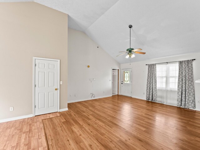 1611 Lincoln St W, Tullahoma, TN 37388 - unfurnished living room with high vaulted ceiling, a ceiling fan, and light wood-style floors