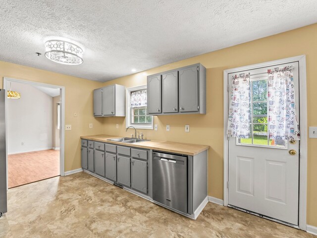 1611 Lincoln St W, Tullahoma, TN 37388 - kitchen with stainless steel appliances, gray cabinets, healthy amount of natural light, light countertops, and a textured ceiling