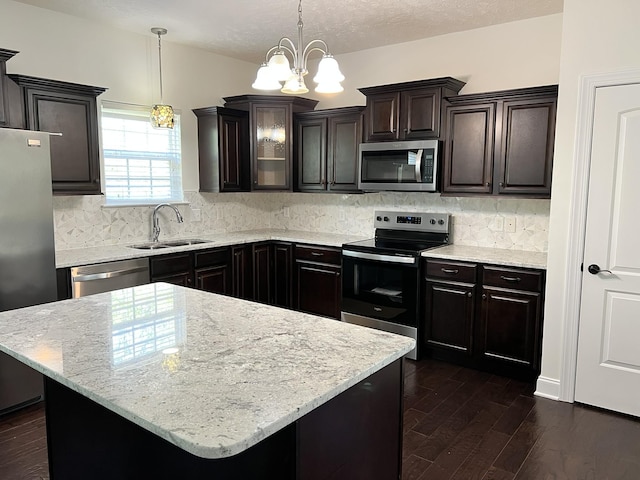 2124 Skyglen Trce, Antioch, TN 37013 - kitchen with appliances with stainless steel finishes, a sink, dark wood-style flooring, a chandelier, and decorative backsplash