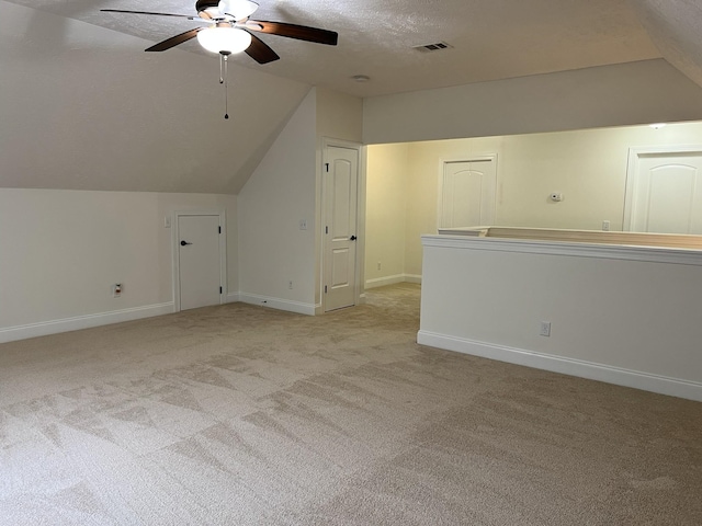 2124 Skyglen Trce, Antioch, TN 37013 - additional living space featuring vaulted ceiling, a ceiling fan, light colored carpet, baseboards, and a textured ceiling