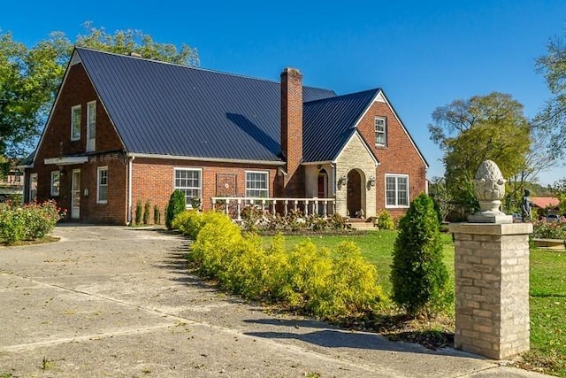109 Walling St, Mcminnville, TN 37110 - english style home with a chimney, brick siding, metal roof, and a standing seam roof