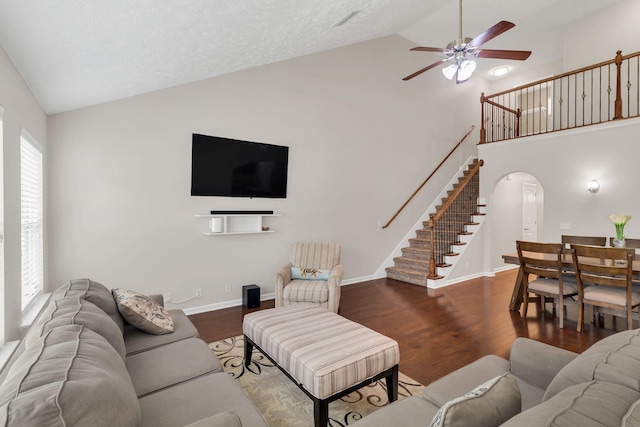 905 Azeri Ave, Murfreesboro, TN 37128 - living room featuring a ceiling fan, stairway, wood finished floors, high vaulted ceiling, and arched walkways