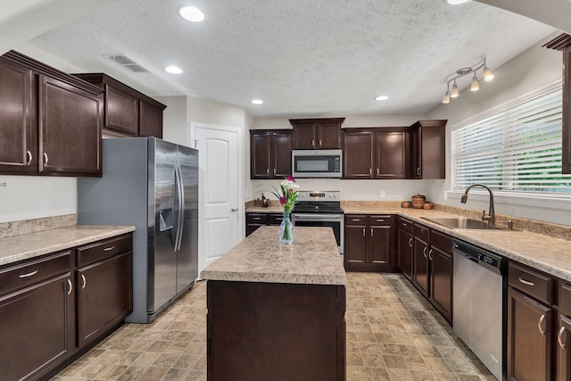 905 Azeri Ave, Murfreesboro, TN 37128 - kitchen featuring appliances with stainless steel finishes, a sink, a textured ceiling, dark brown cabinets, and light countertops