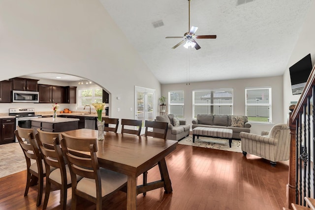 905 Azeri Ave, Murfreesboro, TN 37128 - dining space with ceiling fan, high vaulted ceiling, arched walkways, and wood-type flooring
