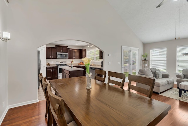 905 Azeri Ave, Murfreesboro, TN 37128 - dining area with arched walkways, high vaulted ceiling, dark wood-style flooring, baseboards, and ceiling fan