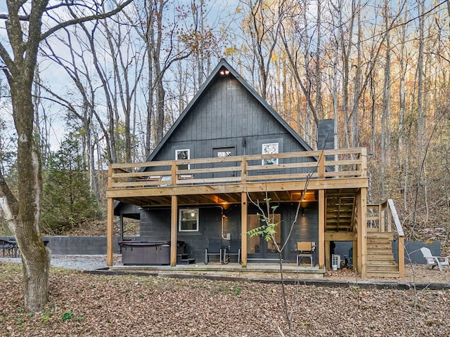 8861 Aunt Helen Rd, Silver Point, TN 38582 - view of front of house featuring a hot tub, a wooden deck, stairs, and a chimney