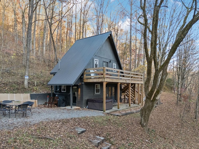 8861 Aunt Helen Rd, Silver Point, TN 38582 - rear view of house with a hot tub, a deck, metal roof, and stairway