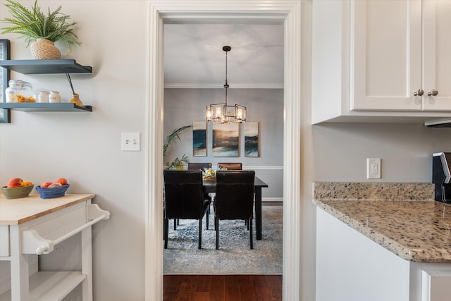 4505 Harding Pike Unit 103, Nashville, TN 37205 - dining space featuring a chandelier, dark wood finished floors, and crown molding