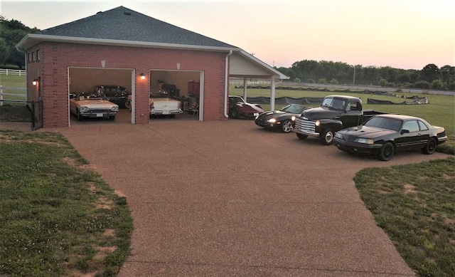 1446 Kittrell Rd, Franklin, TN 37064 - parking at dusk featuring concrete driveway, a lawn, and an attached garage