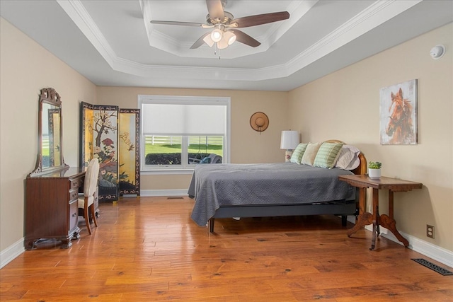 1446 Kittrell Rd, Franklin, TN 37064 - bedroom featuring a tray ceiling, ornamental molding, wood finished floors, and ceiling fan