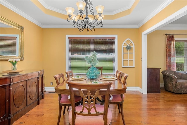 1446 Kittrell Rd, Franklin, TN 37064 - dining space with a tray ceiling, a chandelier, light wood-type flooring, and ornamental molding