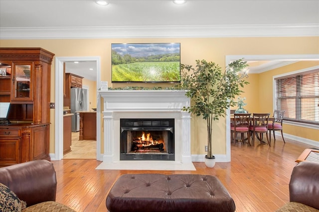 1446 Kittrell Rd, Franklin, TN 37064 - living area with light wood-style floors, crown molding, and a fireplace with flush hearth