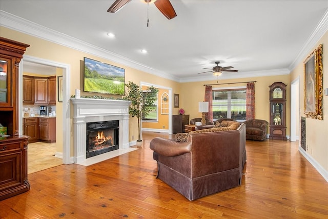 1446 Kittrell Rd, Franklin, TN 37064 - living room with a ceiling fan, a fireplace with flush hearth, ornamental molding, light wood finished floors, and recessed lighting