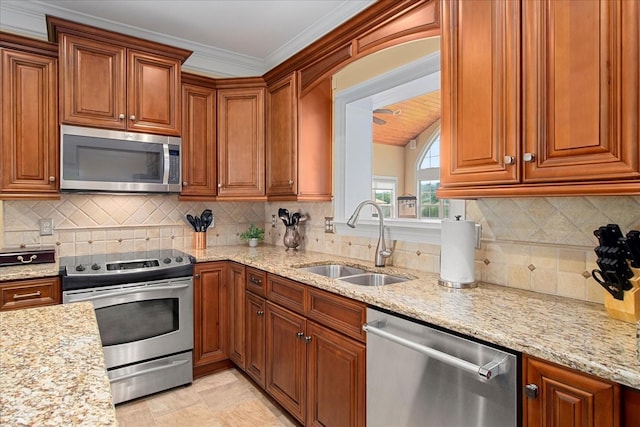 1446 Kittrell Rd, Franklin, TN 37064 - kitchen featuring appliances with stainless steel finishes, brown cabinets, and light stone counters