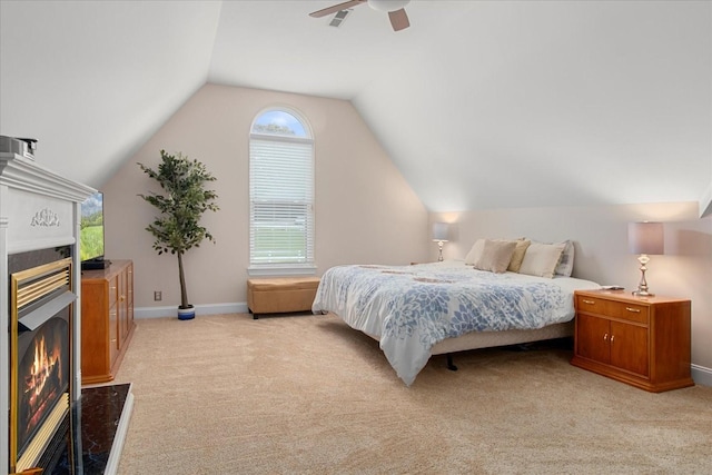 1446 Kittrell Rd, Franklin, TN 37064 - bedroom featuring a warm lit fireplace, light carpet, vaulted ceiling, and ceiling fan