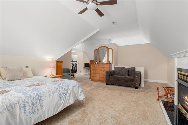 1446 Kittrell Rd, Franklin, TN 37064 - carpeted bedroom featuring lofted ceiling, a walk in closet, a lit fireplace, a ceiling fan, and a closet