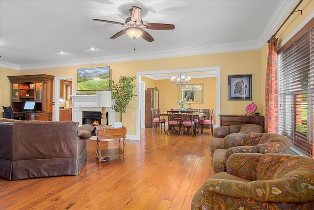 1446 Kittrell Rd, Franklin, TN 37064 - living room with crown molding, a lit fireplace, a chandelier, light wood-type flooring, and a ceiling fan