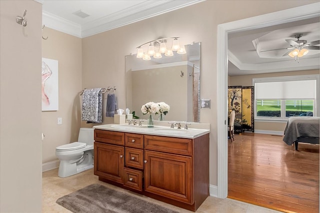 1446 Kittrell Rd, Franklin, TN 37064 - bathroom featuring crown molding, double vanity, a ceiling fan, and wood finished floors
