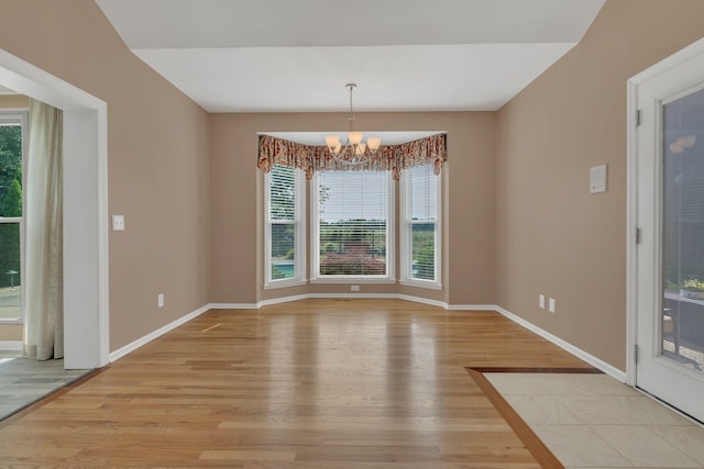 2005 Dunedin Cv, Old Hickory, TN 37138 - unfurnished dining area with a chandelier, light wood-type flooring, plenty of natural light, and baseboards