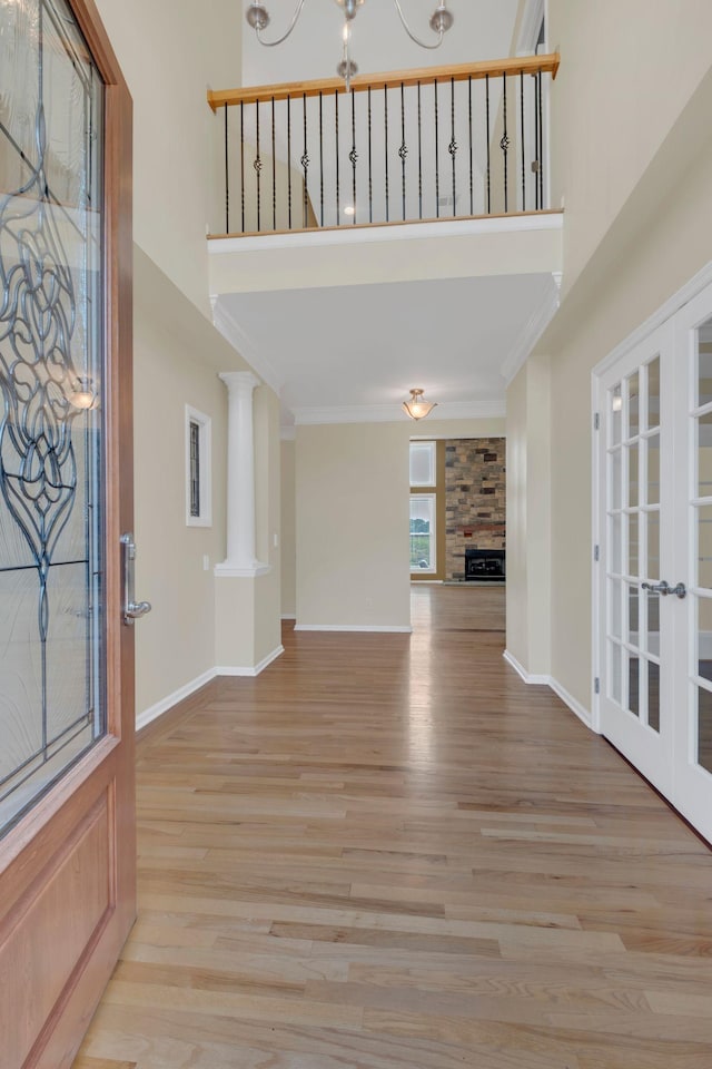 2005 Dunedin Cv, Old Hickory, TN 37138 - entrance foyer featuring a towering ceiling, wood finished floors, crown molding, a fireplace, and baseboards