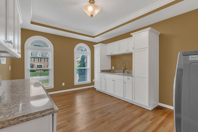 2005 Dunedin Cv, Old Hickory, TN 37138 - kitchen with fridge, a sink, white cabinets, light wood-style floors, and crown molding
