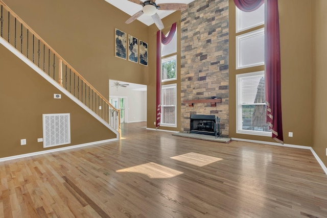 2005 Dunedin Cv, Old Hickory, TN 37138 - unfurnished living room featuring a ceiling fan, a towering ceiling, wood finished floors, baseboards, and stairway