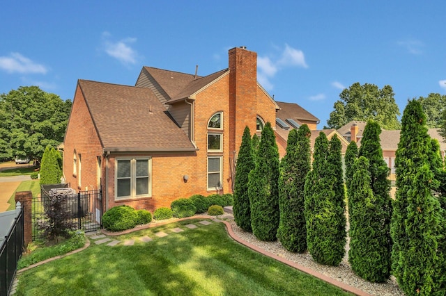 2005 Dunedin Cv, Old Hickory, TN 37138 - rear view of property featuring brick siding, a shingled roof, and a chimney