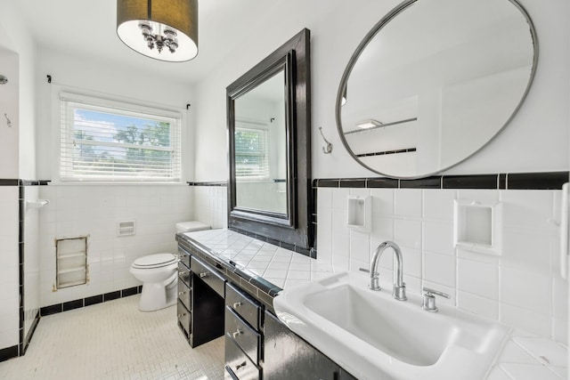1306 Maymont Dr, Murfreesboro, TN 37130 - bathroom featuring tile walls, toilet, tile patterned flooring, vanity, and wainscoting