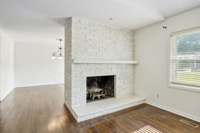 1306 Maymont Dr, Murfreesboro, TN 37130 - unfurnished living room with wood finished floors, baseboards, and a fireplace