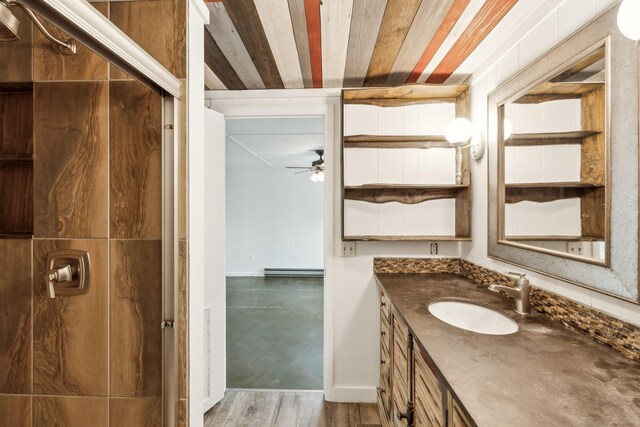 1306 Maymont Dr, Murfreesboro, TN 37130 - bathroom featuring vanity, a baseboard radiator, ceiling fan, and wood finished floors