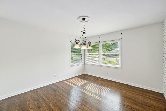 1306 Maymont Dr, Murfreesboro, TN 37130 - empty room featuring baseboards, dark wood-style flooring, and a chandelier