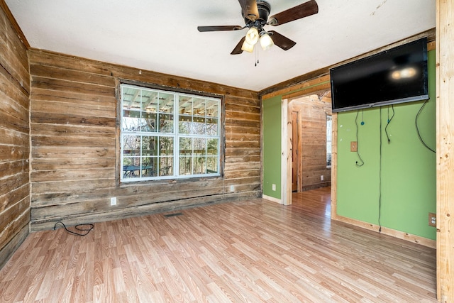 6720 Parker Rd, Lyles, TN 37098 - empty room featuring wood walls, wood finished floors, ceiling fan, and baseboards