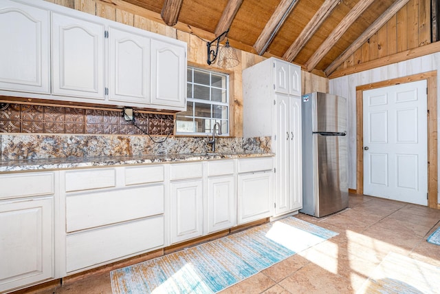 6720 Parker Rd, Lyles, TN 37098 - kitchen with freestanding refrigerator, white cabinets, wood ceiling, tasteful backsplash, and light stone countertops