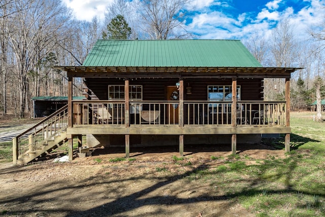 6720 Parker Rd, Lyles, TN 37098 - view of front of home with metal roof, log siding, stairs, and a deck