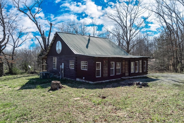 6720 Parker Rd, Lyles, TN 37098 - view of side of property featuring log exterior, metal roof, a lawn, and central air condition unit