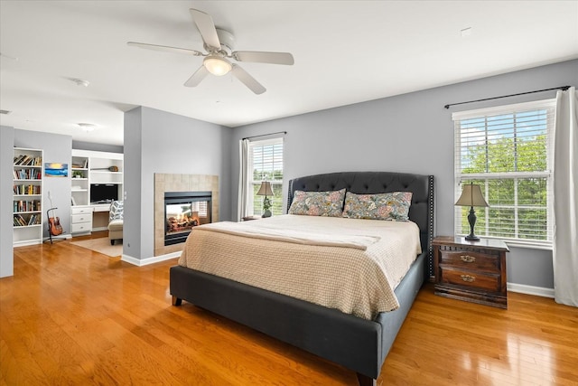 4055 Williford Way, Spring Hill, TN 37174 - bedroom with wood finished floors, baseboards, ceiling fan, and a tiled fireplace