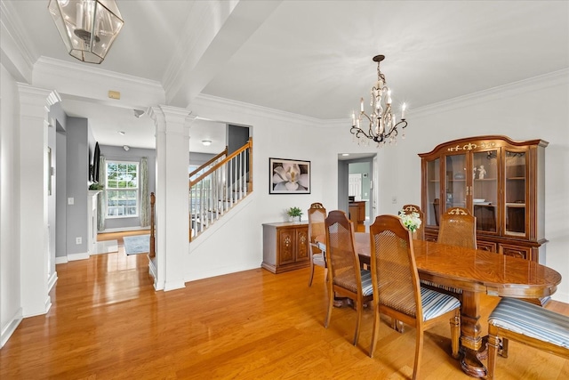 4055 Williford Way, Spring Hill, TN 37174 - dining area featuring ornate columns, light wood finished floors, stairs, ornamental molding, and a chandelier