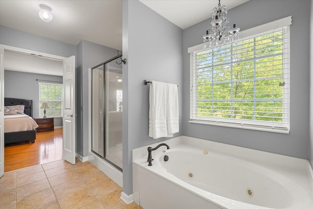 4055 Williford Way, Spring Hill, TN 37174 - ensuite bathroom featuring a stall shower, a whirlpool tub, a chandelier, tile patterned floors, and baseboards
