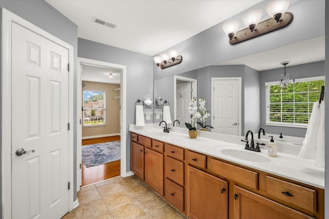 4055 Williford Way, Spring Hill, TN 37174 - full bathroom with double vanity, a chandelier, and baseboards